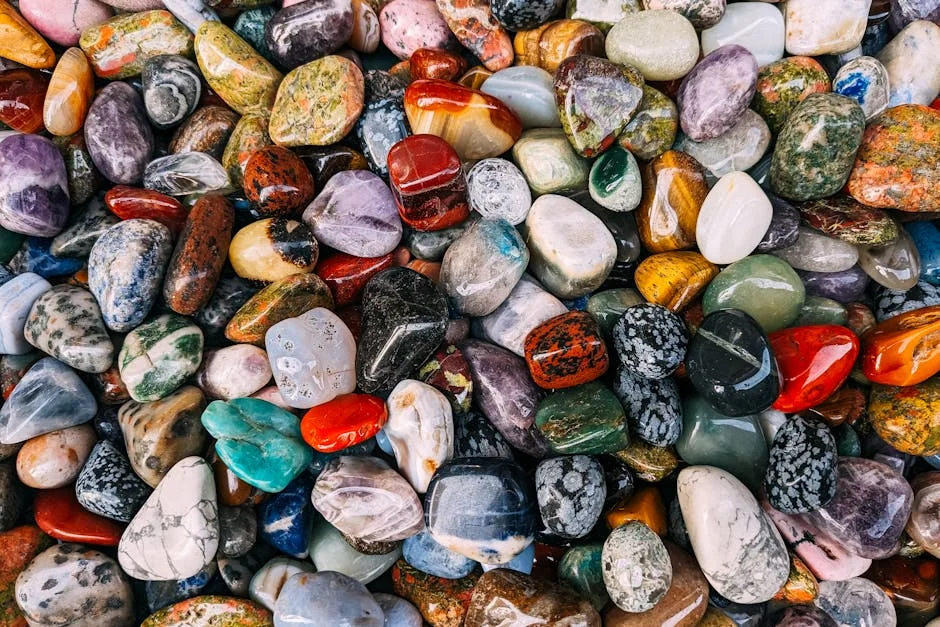 Vibrant assortment of polished gemstones displaying rich colors and textures. - gemstone names for cats