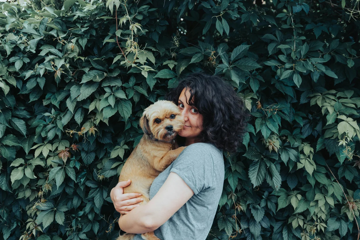 Girl with dog with a green background - human names for dogs