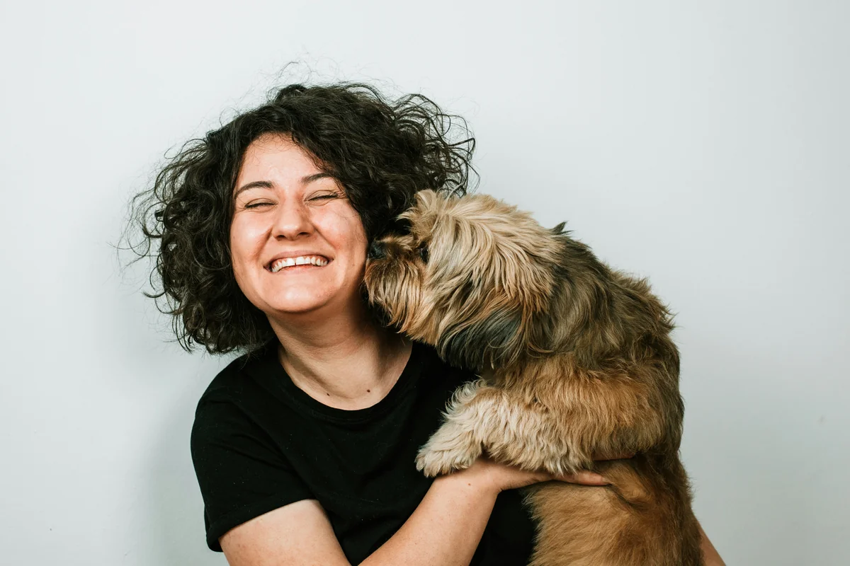 Girl laughing with dog - human names for dogs