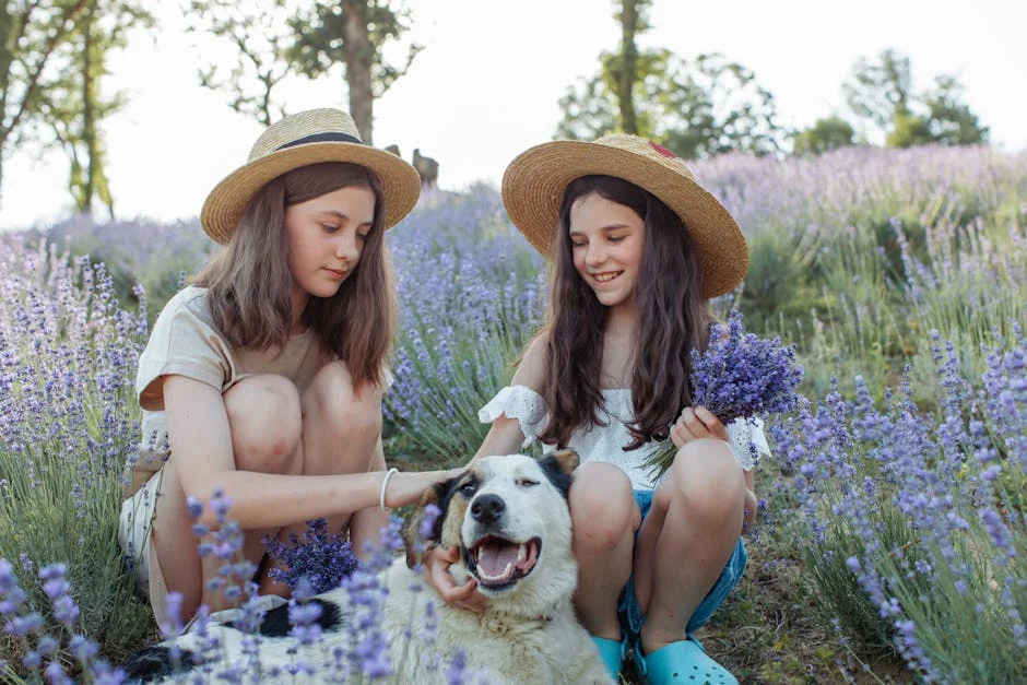 Two girls with straw hats and a dog enjoying lavender fields. Capturing youthful joy and nature's beauty. - nature inspired pet names for girls