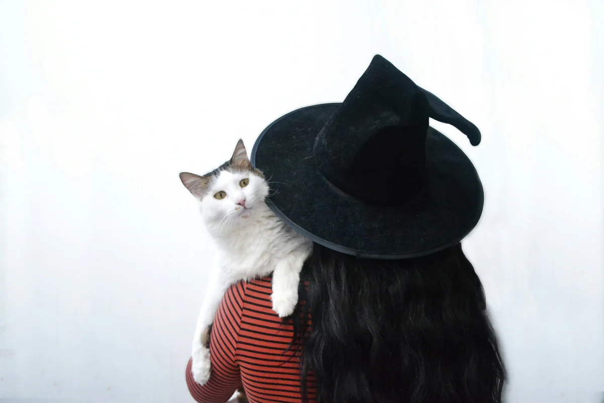 woman carries cat - witchy cat names
